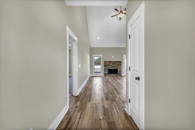 hall with wood-type flooring and a high ceiling