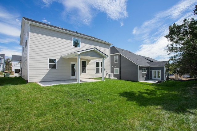 back of property featuring a yard and a patio area