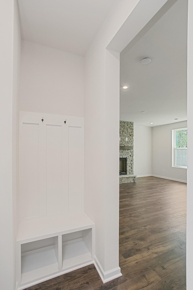 mudroom featuring dark hardwood / wood-style flooring and a fireplace