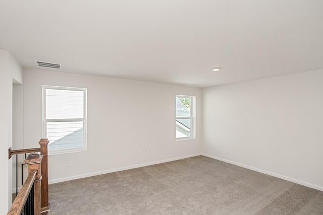 unfurnished room with light carpet