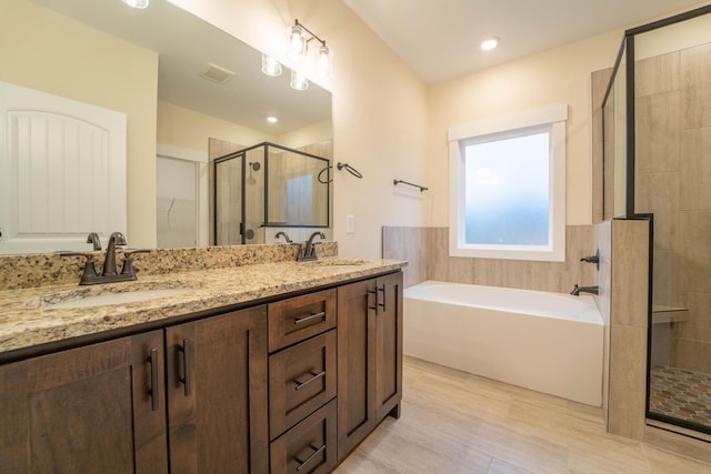 bathroom featuring vanity and separate shower and tub