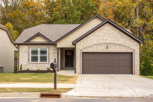 view of front of house featuring a garage and a front lawn