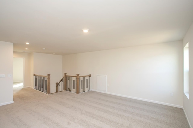 unfurnished room with light carpet