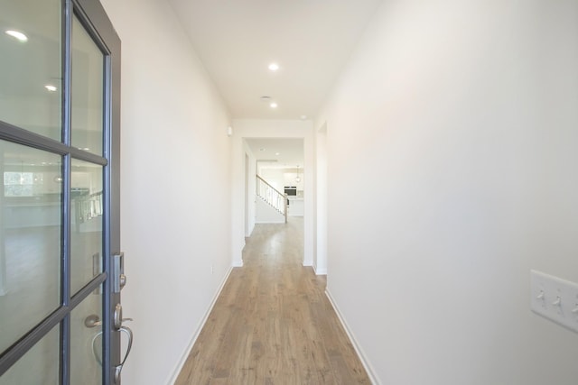 hall with light hardwood / wood-style floors