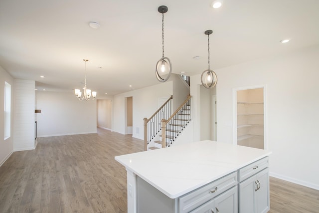 kitchen featuring a kitchen island, pendant lighting, and light hardwood / wood-style floors