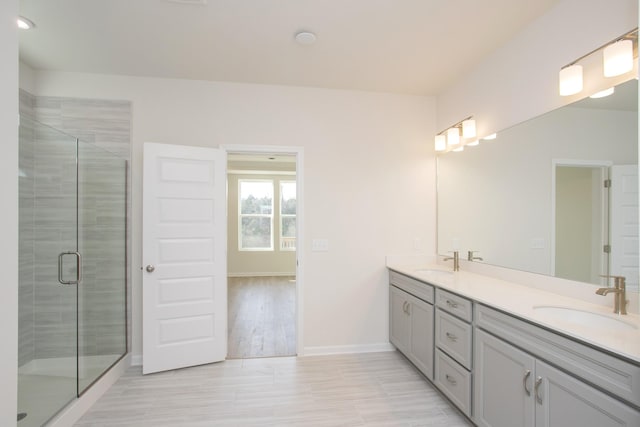 bathroom featuring vanity and an enclosed shower