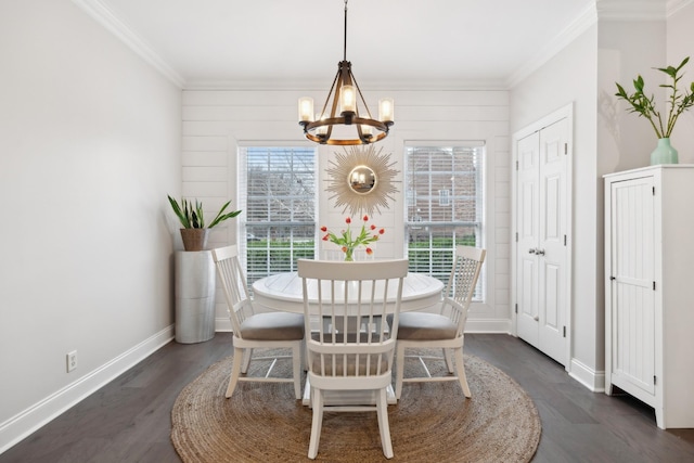 dining room with an inviting chandelier, crown molding, and dark hardwood / wood-style flooring