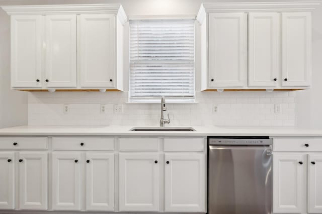 kitchen featuring dishwasher, sink, white cabinets, and backsplash