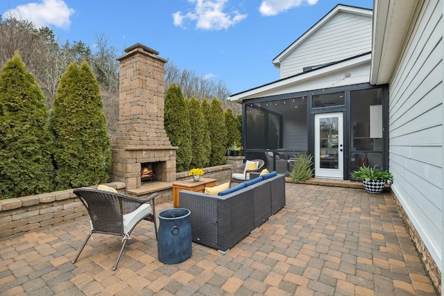 view of patio with an outdoor living space with a fireplace