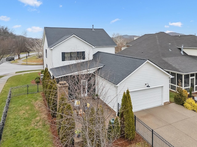 view of front of home with a garage and a front lawn