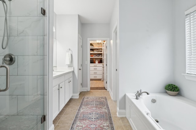 bathroom featuring independent shower and bath, vanity, plenty of natural light, and tile patterned flooring