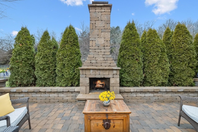 view of patio with an outdoor stone fireplace