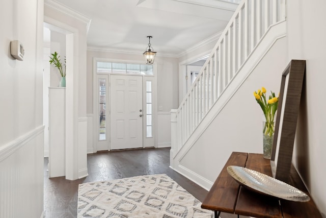 entryway featuring crown molding, dark wood-type flooring, and a healthy amount of sunlight