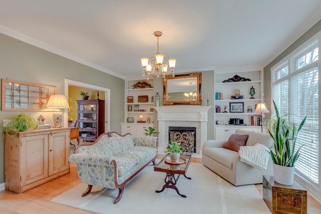 sitting room with ornamental molding, an inviting chandelier, built in features, and light hardwood / wood-style floors