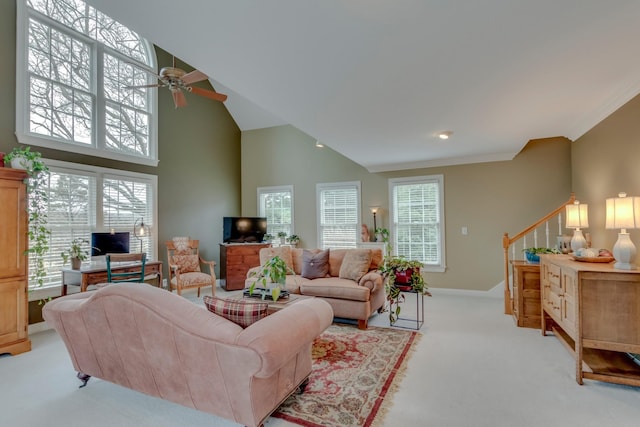 carpeted living room with ornamental molding, high vaulted ceiling, and ceiling fan