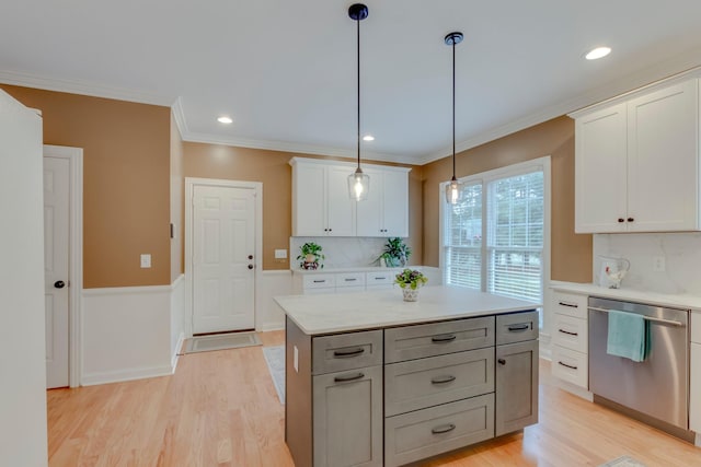 kitchen featuring white cabinetry, decorative light fixtures, light hardwood / wood-style flooring, dishwasher, and a kitchen island