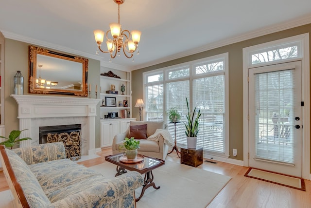 sitting room with crown molding, plenty of natural light, and light wood-type flooring