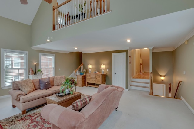 living room with ornamental molding, a towering ceiling, and light carpet