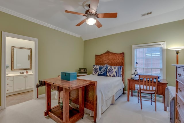 carpeted bedroom with sink, ensuite bath, ornamental molding, and ceiling fan