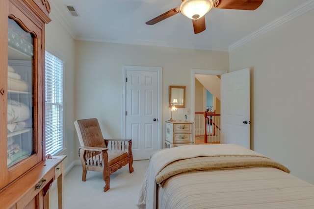 bedroom featuring carpet floors, ornamental molding, and ceiling fan