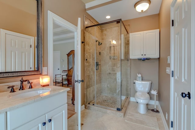 bathroom featuring an enclosed shower, vanity, crown molding, and toilet