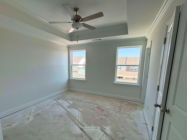 spare room featuring ceiling fan, ornamental molding, plenty of natural light, and a raised ceiling