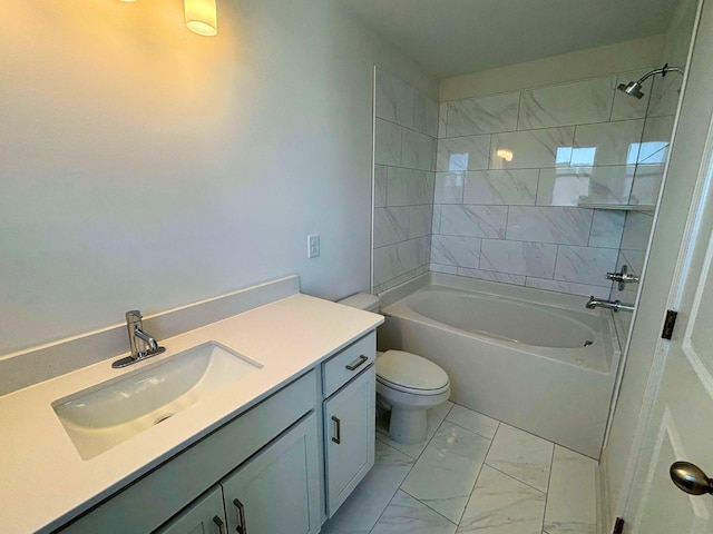 full bathroom featuring vanity, tiled shower / bath, and toilet