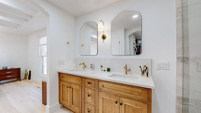 bathroom with vanity, hardwood / wood-style floors, and a shower with door