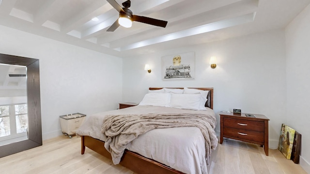 bedroom with ceiling fan, light hardwood / wood-style floors, and beamed ceiling