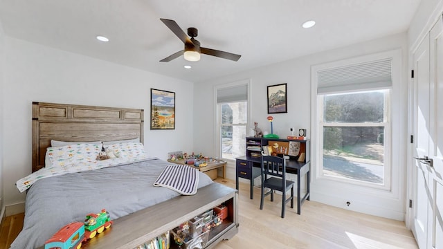 bedroom with light hardwood / wood-style flooring and ceiling fan