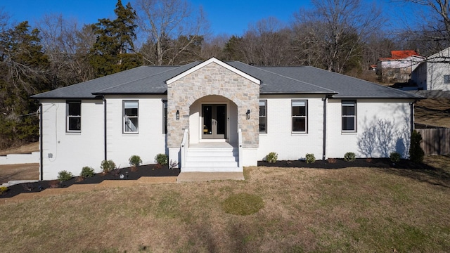 ranch-style home with french doors and a front lawn