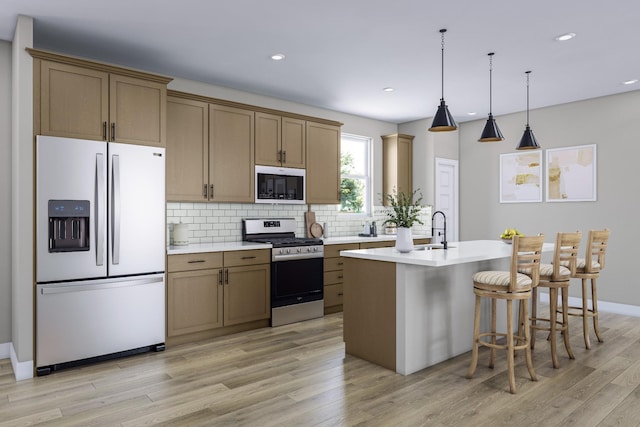 kitchen with a kitchen island with sink, stainless steel range with gas stovetop, fridge with ice dispenser, light hardwood / wood-style floors, and decorative backsplash