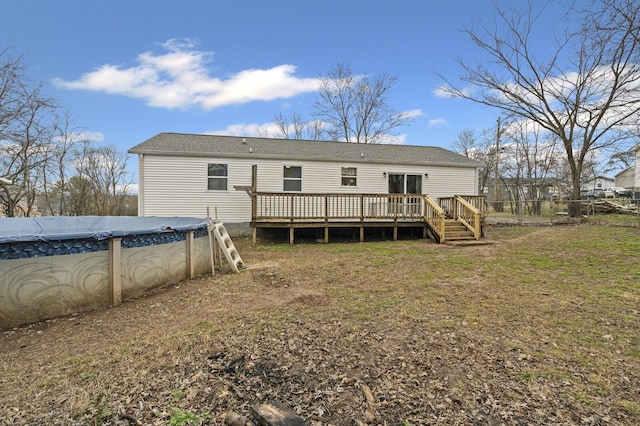 back of house with a pool side deck