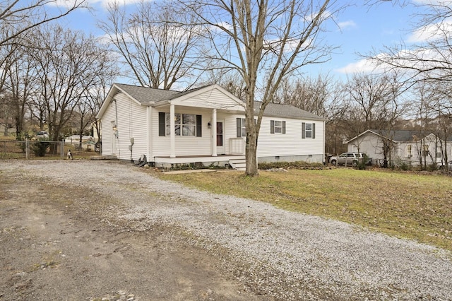 view of front facade featuring a front lawn and covered porch