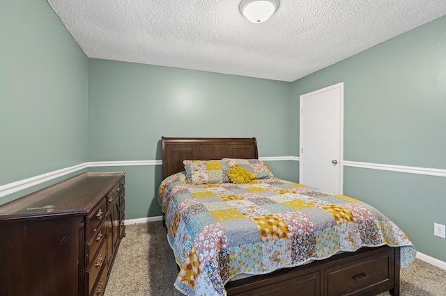 carpeted bedroom featuring a textured ceiling