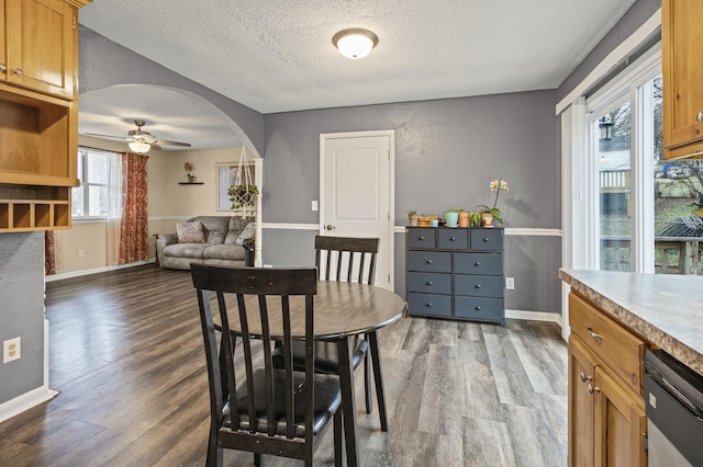 dining room with hardwood / wood-style flooring, a textured ceiling, and ceiling fan