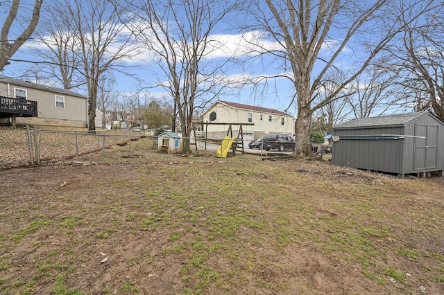 view of yard featuring a storage shed and a playground