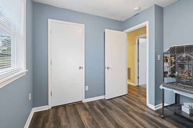 interior space with dark hardwood / wood-style floors and a textured ceiling