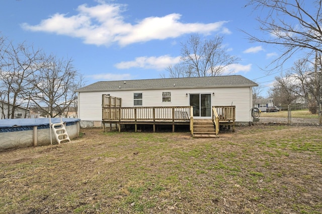 back of property featuring a swimming pool side deck and a yard