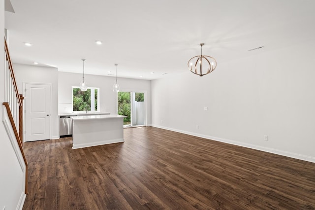 unfurnished living room featuring dark hardwood / wood-style floors and a chandelier