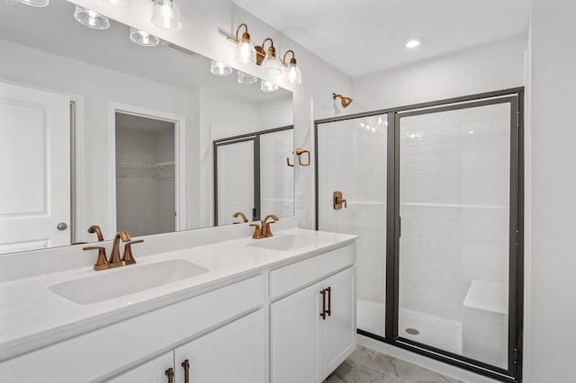 bathroom featuring vanity and a shower with shower door