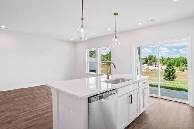 kitchen with white cabinetry, sink, hanging light fixtures, a kitchen island with sink, and stainless steel dishwasher