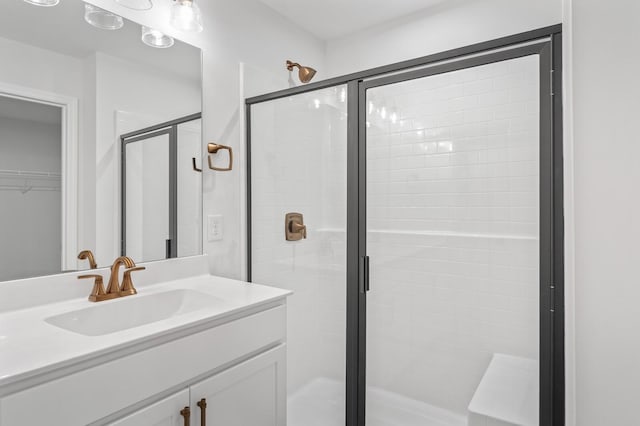 bathroom with vanity and a shower with shower door