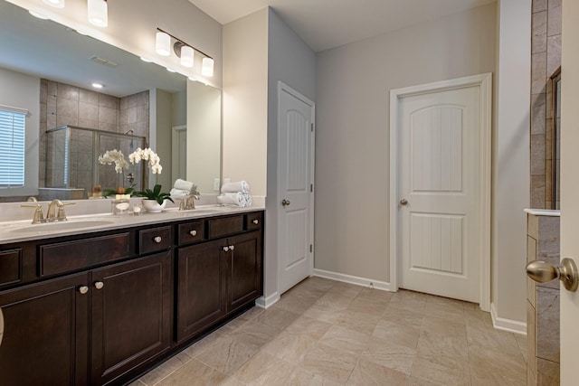 bathroom with an enclosed shower and vanity