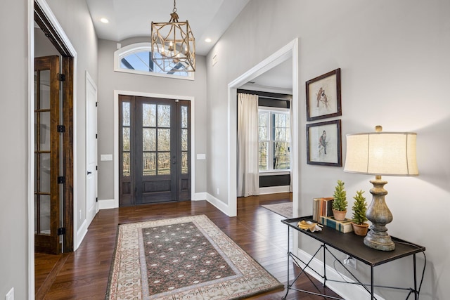 entrance foyer with dark wood-type flooring and a notable chandelier