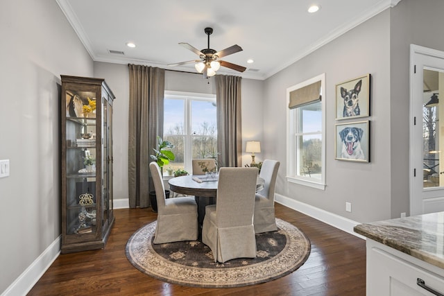 dining space with ornamental molding, dark wood-type flooring, and ceiling fan