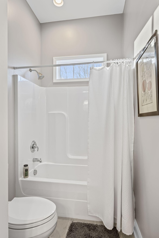 bathroom featuring shower / bath combination with curtain, toilet, and tile patterned flooring