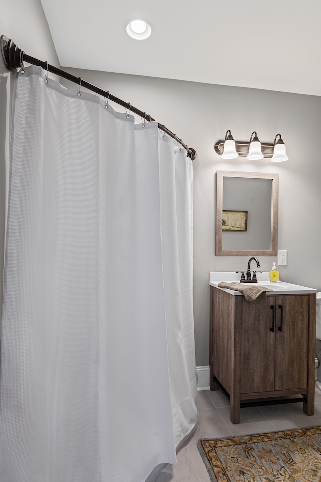 bathroom featuring tile patterned flooring and vanity