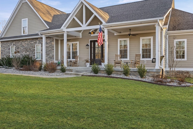 view of front facade with a porch, a front yard, and ceiling fan