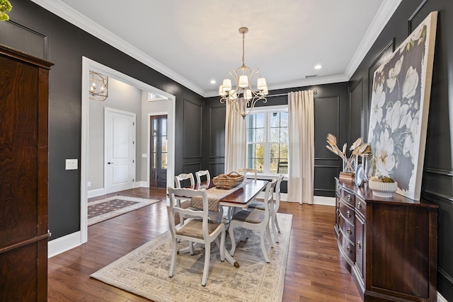 dining room featuring ornamental molding, dark hardwood / wood-style floors, and a chandelier